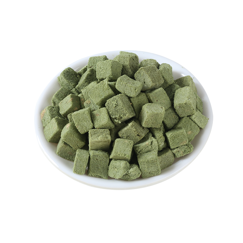 Green freeze-dried cat grass bites in a white bowl